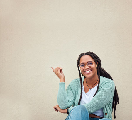 Black woman, portrait and hands pointing to mockup, advertising or empty background, laugh and excited. Hand gesture, face and girl relax in studio while showing wall copy space or isolated marketingの写真素材