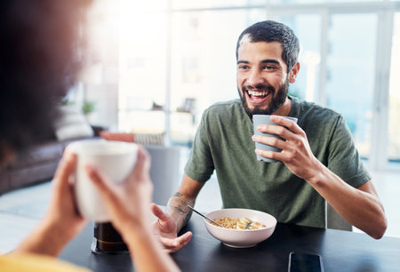 I love how easy it is to open up with her. a young couple having breakfast together at home.の写真素材