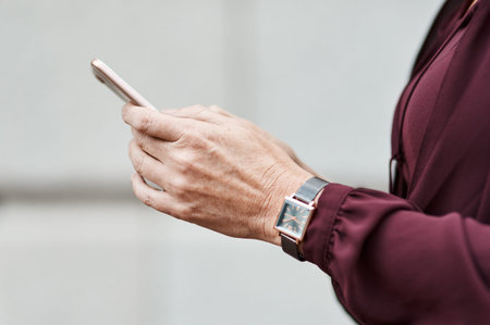 Sometimes its your hands that say hello. an unrecognisable businesswoman using a smartphone against...