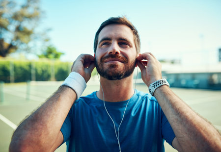 Music helps me get into the right mood before a match. a sporty young man listening to music while...