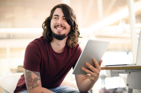 Passion for work is as important as engagement. a young businessman using a digital tablet in an...