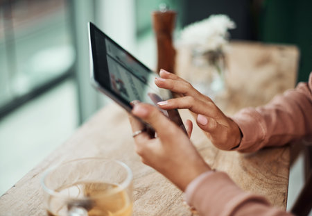 The world is waiting to be explored online. a woman using a digital tablet at a cafe.