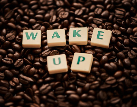 Life begins after coffee. Closeup shot of block letters forming the words wake up on a pile of coffee beans.の写真素材