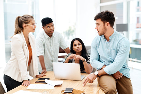 Producing new and creative ideas as a team. a group of businesspeople having a discussion in an...