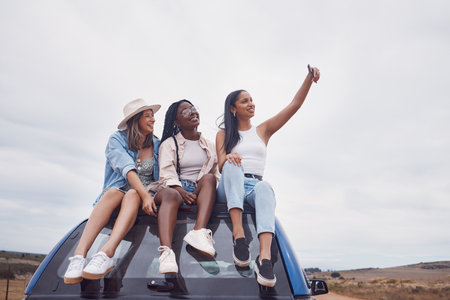 Road trip selfie of women friends on car roof with sky mockup for social media, group travel and vacation. Profile picture of diversity youth or people in Africa safari, desert or countryside journeyの写真素材