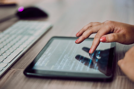 Hands, tablet screen and programmer typing in office, coding or programming on desk. Information technology, female developer and woman with digital touchscreen for software development in workplace.の写真素材