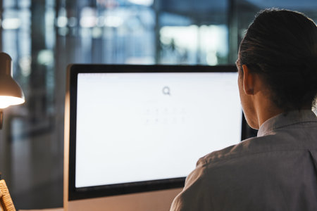 Man, computer and green screen on mockup at night for advertising, marketing or branding at the...