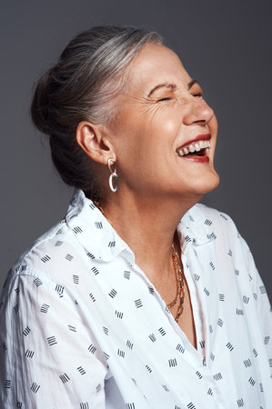 You can feel however you want to feel. Studio shot of a senior woman posing against a grey background.の写真素材
