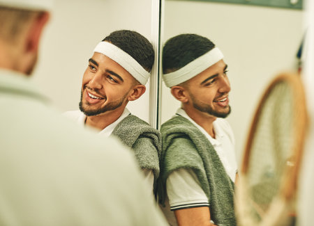 What a game. two young men chatting in the locker room after a game of squash.の写真素材