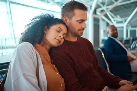 Airport, travel and woman sleeping by her boyfriend while waiting to board their flight together. Tired, exhausted and female taking a nap for rest on the shoulder of her man in the terminal lounge.の写真素材