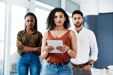 We work hard and dream big. Cropped portrait of an attractive young businesswoman standing in front...