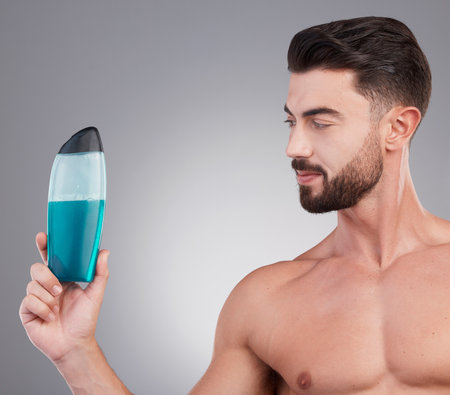 Skincare, beauty and shower gel with man and product with mockup for spa treatment, wellness and hygiene. Fresh, cosmetics and hydration with model holding bottle for health, grooming and cleaningの写真素材
