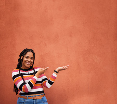 Mockup, portrait or happy black woman with marketing, product placement or branding space on wall background. African gen z girl advertising discount deal news, sales offer or promotion announcementの写真素材
