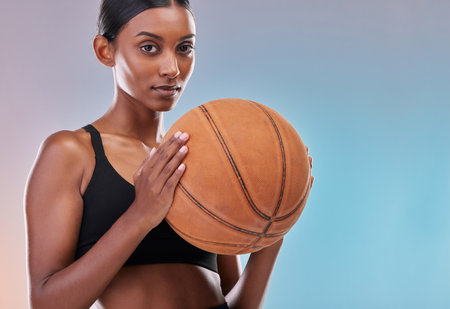 Basketball portrait, sports and training woman ready for workout challenge, practice game or fitness competition. Performance studio, health exercise or mockup athlete isolated on gradient backgroundの写真素材