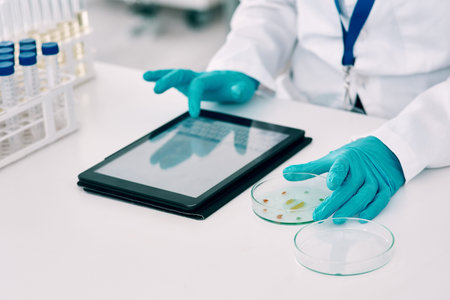 She uses technology throughout all her experiments. an unrecognizable female scientist using a...