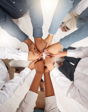 Teamwork, diversity and group holding hands in circle for support, trust and team building together....