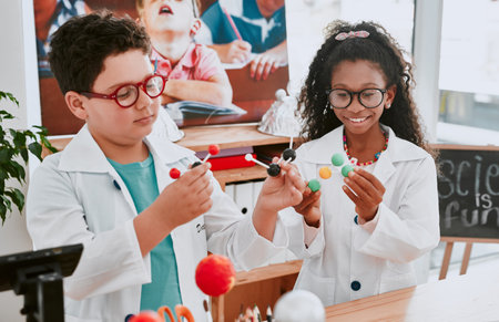 Theyre the future of science. an two adorable young school children learning about molecules in...