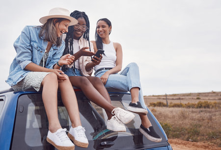 Car, road trip and happy friends with phone, social media post and countryside adventure on sky...