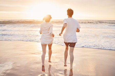Couple at beach, running to ocean with travel and freedom outdoor, love and care in relationship...