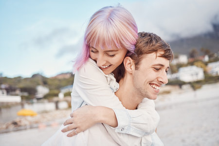 Love, beach and piggy back, couple on date for valentines day, ocean fun and romantic embrace at sunset. Romance, happiness and smile, gen z woman and man on tropical valentine holiday in Indonesia.の写真素材