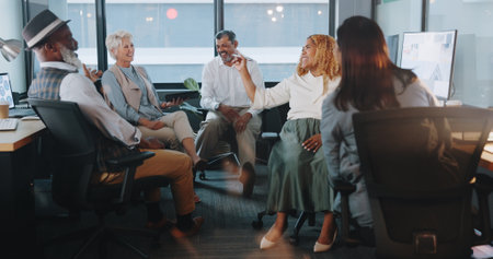 Business people, communication and team with diversity in workplace, coworking space and collaboration with tablet. Excited senior employee, talking and news with networking, productivity and reviewの写真素材