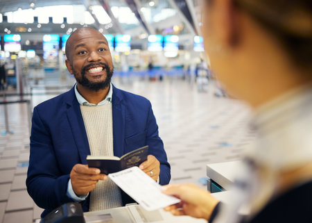 Airport, ticket booking and black man smile for customer services desk and passport registration. Excited USA business person and travel agent helping with flight identity document and hospitalityの写真素材