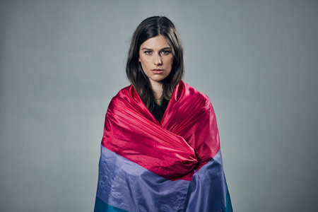 Bisexual flag, pride and woman in portrait, lgbtq and freedom to love, inclusion and equality, protest for human rights. Gay, trans and lesbian identity, politics and community on studio backgroundの写真素材
