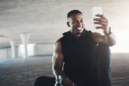 One for the profile. a handsome young man taking selfies while exercising outside.の写真素材