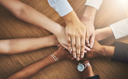We cant do it without each other. Closeup shot of a group of businesspeople joining their hands...