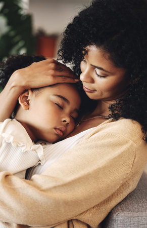 Family, mother with sleeping child and love, peace and calm with relationship, care and relax at home. Content, black woman and tired girl with bond, comfort and hug with safe place, dream and sleepの写真素材