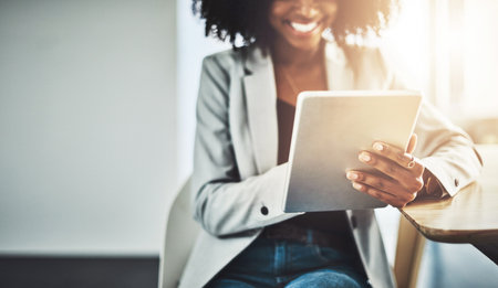 Take your business online and watch it grow. Closeup shot of a businesswoman using a digital tablet in an office.の写真素材