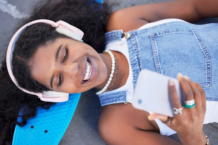 Top view, music headphones and black woman with phone for streaming podcast and radio. City...