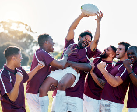 Sports, winner and rugby team with ball in celebration for winning match, game and sport competition. Fitness, teamwork and happy, excited athletes on field celebrate victory, success and motivationの写真素材