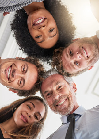 Meet the management team. Low angle portrait of a group of businesspeople huddled together in...