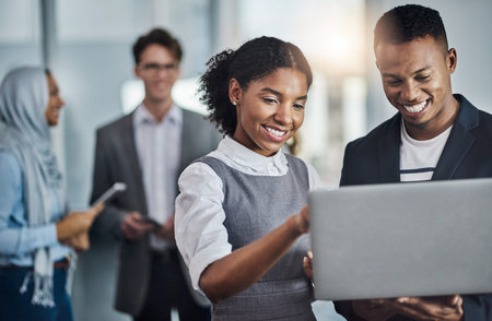 Teamwork goes a long way. a group of young cheerful businesspeople browsing on digital devices while...