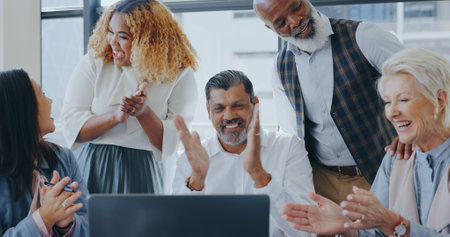 Laptop applause or business people happy with success or winning digital marketing business deal. CEO, senior manager and excited employees meeting for good news, kpi goals or sales target in officeの写真素材