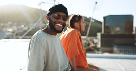 Black couple, smile and portrait on rooftop in city, outdoors and bonding. Diversity, sunglasses and happy man, woman and relax, love and having fun, enjoying view and spending quality time together.の写真素材
