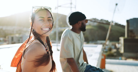 Wind, fashion and woman on city rooftop for summer break, Portugal holiday or vacation location with style, trendy or cool clothes. Portrait, smile or happy student or tourist bonding with black manの写真素材