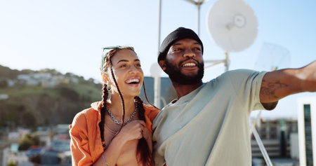 Couple, bonding or talking on city rooftop and pointing, sightseeing Portugal or enjoying summer holiday vacation view. Smile, happy and love black man and interracial fashion woman on location dateの写真素材