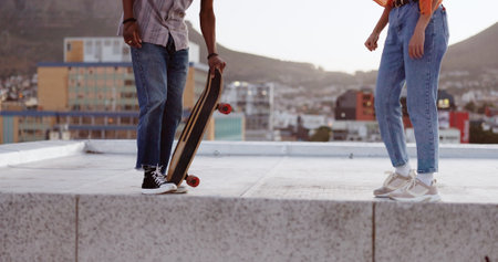 Skateboard, friends and city with a man and woman skating on a rooftop outdoor during the day. Sport, exercise and summer with a male and female training as a street skater in an urban townの写真素材