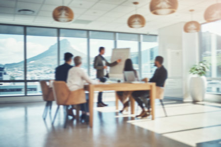 Success in the making. Blurred shot of a group of businesspeople having a meeting in an office.の写真素材