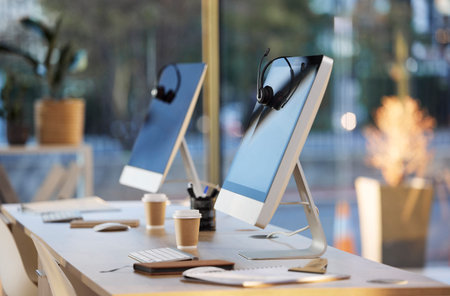 Call center, computer and crm headphones with no people in office for web consulting. Contact us,...