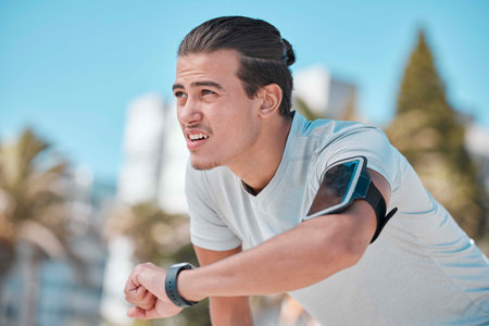 Smart watch, outdoor workout and man tired from exercise, fitness and running. Stopwatch time,...