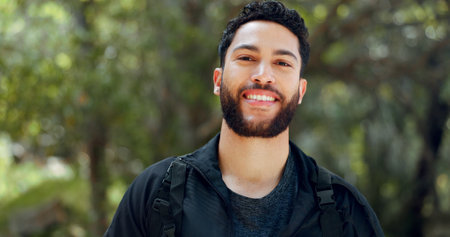 Young man portrait, nature hiking and freedom, travel and adventure in peace, calm and morning hike outdoors. Happy, fitness and smile arab guy, trekking travel and summer park in Egypt environmentの写真素材