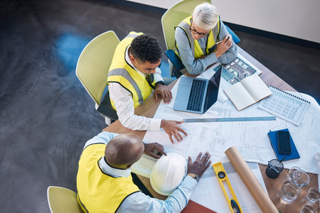 Architect, laptop and team in meeting above for construction or building planning strategy at...