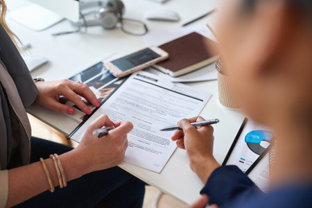 Signature, planning and business people with a contract for employment, deal and agreement. Meeting, legal and corporate employees reading and writing on a professional document for an applicationの写真素材