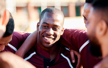 Sports, huddle and man athlete on a field for motivation or strategy planning with his team....