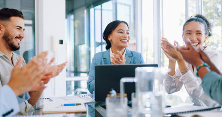 Business people in meeting, applause and screen, black woman speaker and presentation, leadership and infographic. Support, team and diversity, success and win, marketing strategy and data analyticsの写真素材