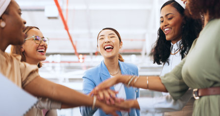 Business team, hands together and celebration of teamwork with women for collaboration, project management and team building in a office. Diversity female employees with motivation for successの写真素材