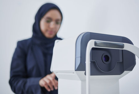 Optometry, ophthalmology and Muslim woman with a machine for vision correction and surgery. Test,...